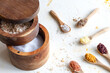 © Leire Gamboa/ADDICTIVE STOCK - Top view of various types of salt in wooden jars and spoons placed on white table in kitchen