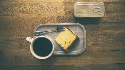 Canvas Print - Top view of a coffee mug near a dessert on a wooden table