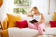 © Miguel Cano/ADDICTIVE STOCK - Peaceful young female in comfy clothes lying on soft couch and reading interesting book in stylish apartment