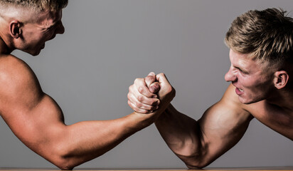 Wall Mural - Arm wrestling. Two men arm wrestling. Rivalry, closeup of male arm wrestling. Two hands. Men measuring forces, arms. Hand wrestling, compete. Hands or arms of man