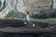 © Pablo Garcia/ADDICTIVE STOCK - Focused female athlete in summer sportswear jumping during workout while doing cardio exercises in highlands