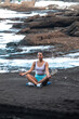 © Pablo Garcia/ADDICTIVE STOCK - Peaceful female sitting in Lotus pose with mudra hands and meditating while doing yoga and practicing mindfulness on beach near sea