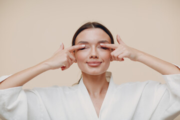 Young woman doing face building facial gymnastics self massage and rejuvenating exercises