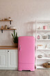© sergiophoto - Kitchen shelves, wooden surface and pink fridge on white background. White kitchen interior counter top.