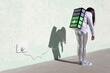 © Sergio Victor Vega/ADDICTIVE STOCK - Side view of young fit female in trendy outfit standing on street with creative backpack connected to charger and having phone conversation