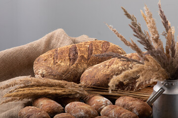 Freshly baked handmade bread with linen textile and dried bents