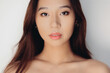 © Victor Torres/ADDICTIVE STOCK - Portrait of naked young Chinese woman looking at camera over white background