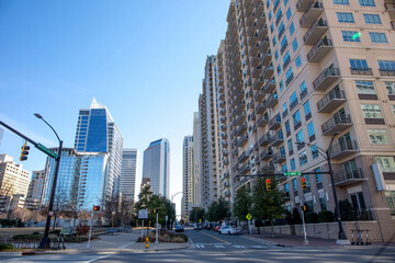 A view of the Charlotte, North Carolina, skyline in a bright blue sky as seen from the intersection of W. Martin Luther King, Jr. Blvd. and S. Mint St.