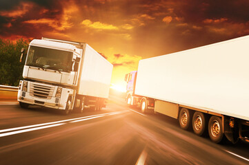 Canvas Print - Abstract background with trucks on a road against a sky with a sunset