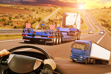 Canvas Print - Abstract background with trucks on a road, truck steering wheel against a sky with a sunset