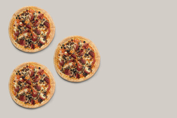 The pizzas are delicious and the ingredients are sausage, bacon and mozzarella on a brown background. can be made of backgrounds, flyers and other forms of advertising,