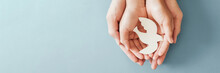 Adult And Child Hands Holding White Dove Bird On Blue Background, International Day Of Peace Or World Peace Day Concept, Sustainable Consumption, Csr Responsible Business Concept