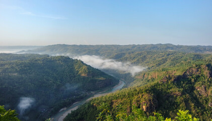 Wall Mural - Beautiful morning landscape with mountains and river at Jurang Tembelan (kebun buah mangunan) Yogyakarta, Indonesia - Beautiful nature, Indonesia landscape.