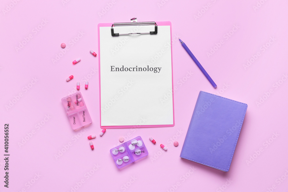 Clipboard with word ENDOCRINOLOGY and pills on color background