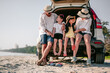 © Garun Studios - Happy asian family enjoying road trip with their favorite car. Parents and children are traveling the way to the sea or ocean.Holiday and travel family concept, Summer vacations.