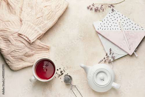 Composition with teapot and cup of tea on light background © Pixel-Shot