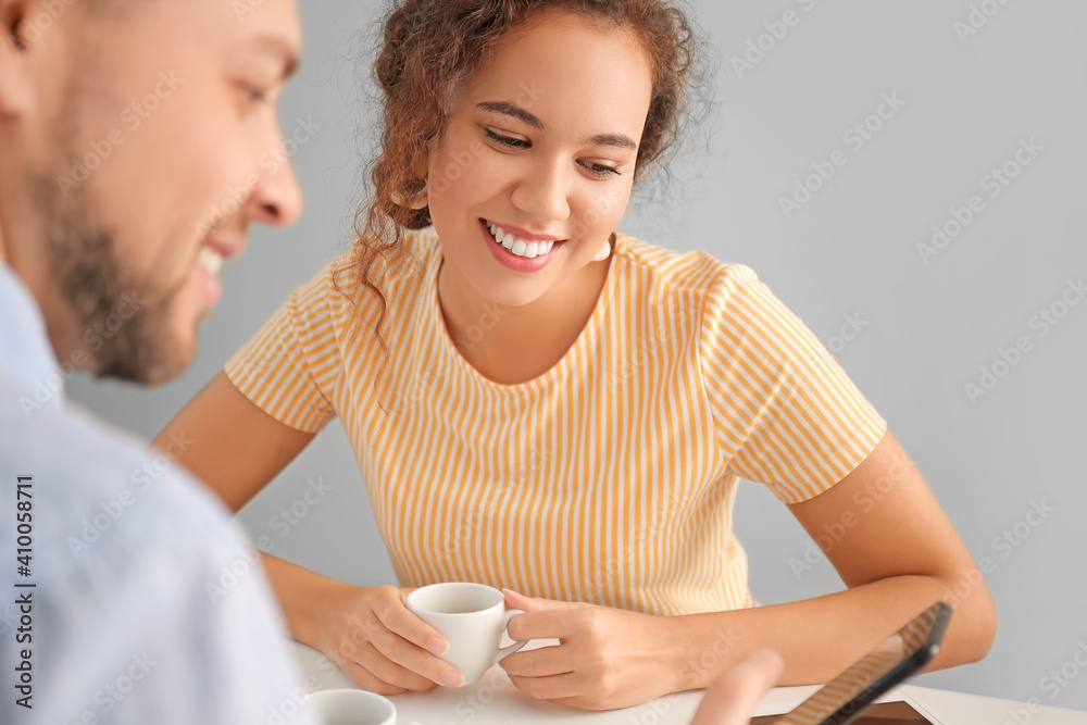 Happy couple drinking hot espresso on romantic date in cafe