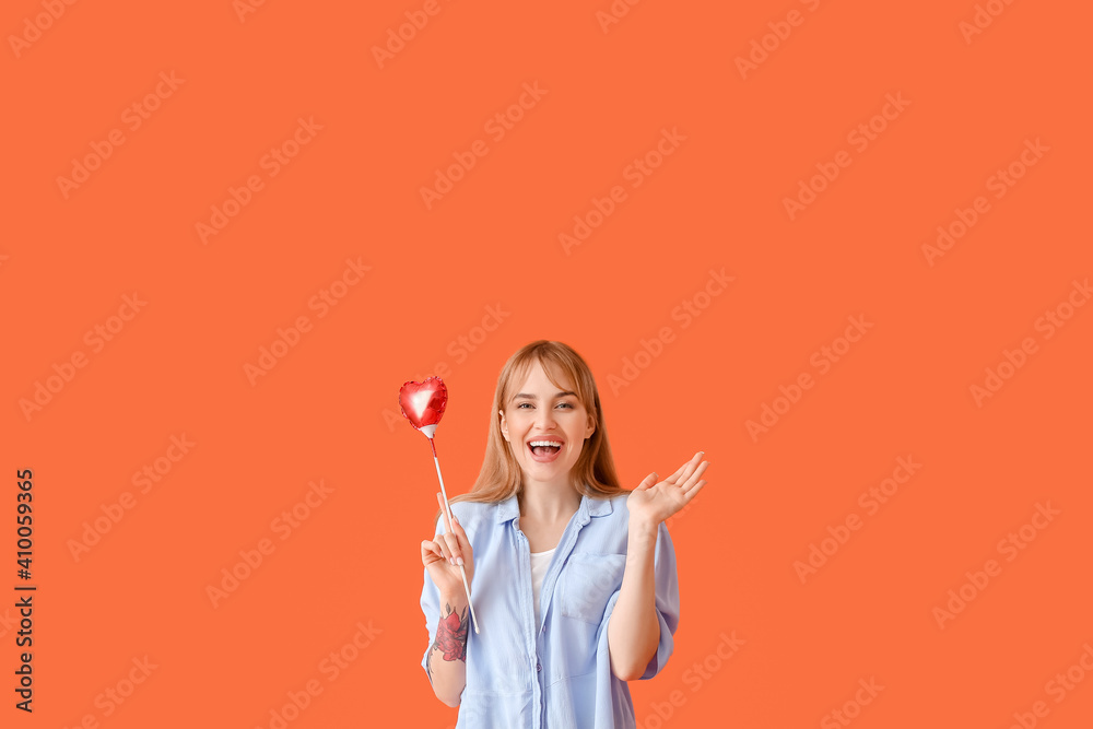 Young woman with air balloon on color background. Valentine's Day celebration