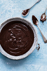 Wall Mural - Chocolate ganache being stirred in a bowl food photography