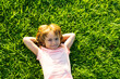 © Volodymyr - Cute child lying on grass background. Happy freedom kid boy enjoying on field and dreaming. Unity with nature.