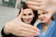© Artem Zakharov - Two girls take selfies in the city