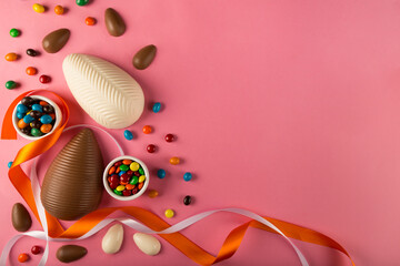 Sticker - Easter. Composition with chocolate Easter eggs on pink background, space for text.