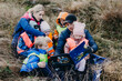 © Johnér - Playschool teachers reading book to children during walk