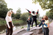 © Johnér - Group of teenagers walking on benches at river