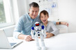 © epiximages - Technology concept. Parent and son working and playing with a robot.