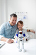 © epiximages - Technology concept. Parent and son working and playing with a robot.
