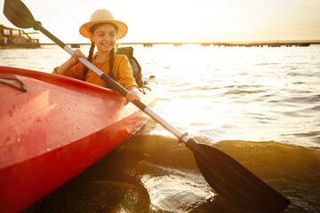 Poster - Happy girl kayaking on river. Summer camp activity