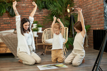 Mom daughter and son put the puzzle together on the floor. Family entertainment. Woman girl and boy play together