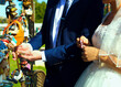 © Evgenij - Young couple, bride and bridegroom, putting lock on fence of a bridge during wedding. Romantic event and tradition. Married people.