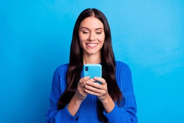 portrait of brunette nice optimistic lady look telephone wear blue sweater isolated on bright color 