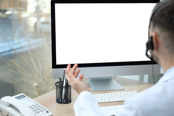 Poster - Doctor with headset consulting patient online at desk in clinic, space for text. Health service hotline