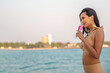 © ic36006 - Sexy Asian Women in Bikini with Champagne Glass on her Private Yacht at Sunset.
