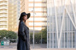 © Raul Mellado - elegant asian woman in hat walking downtown