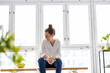 © pikselstock - Portrait of a smiling creative woman in a modern loft space