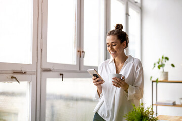 creative business woman using smartphone in loft office