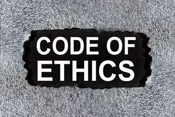 Fototapete - code of ethics, text on a black background in white letters