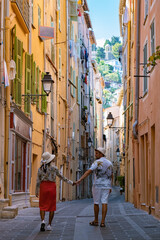 Wall Mural - View on old part of Menton, Provence-Alpes-Cote d'Azur, France Europe during summer, couple men and woman on vacation at Menton France