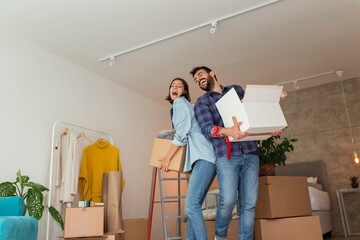 Wall Mural - Couple carrying cardboard boxes with their possessions while moving in together