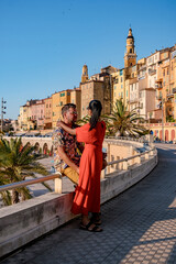 Wall Mural - View on old part of Menton, Provence-Alpes-Cote d'Azur, France Europe during summer, couple men and woman on vacation at Menton France