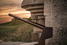 Atlantic Wall Concrete German World War Two Gun Emplacement Fortification Bunker Battery At Longues-sur-mer In Normandy Gold Beach France Remains Lay In Ruins With Beautiful Orange Sunset Sky