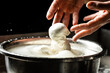 © Надія Коваль - The homemade cheese maker produces handmade mozzarella with fresh bio milk. process of making mozzarella. Italian hard cheese silano or caciocavallo in cheesemaker hands