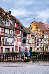 Wall Mural - Beautiful view of colorful romantic city Colmar, France, Alsace . Europe Couple mid age men and woman on Vacation Colmar France