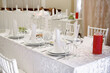 © mirage_studio - Table setting with sparkling wineglasses, plate with white napkin and cutlery on table, copy space. Place set at wedding reception. Table served for wedding banquet in restaurant