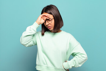 Wall Mural - young hispanic woman looking stressed, tired and frustrated, drying sweat off forehead, feeling hopeless and exhausted