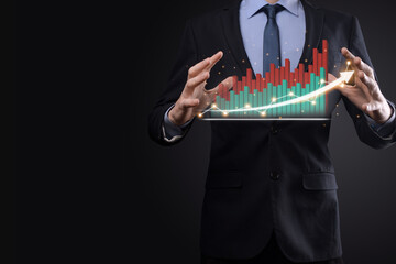 Businessman on a black background presses, presses a finger on a positive growth arrow. Graphs of indicators. Business development and finance concept