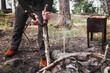 © Александр Пашнин - Man prepares tourist campfire. Hands in the frame put a tree for a fire